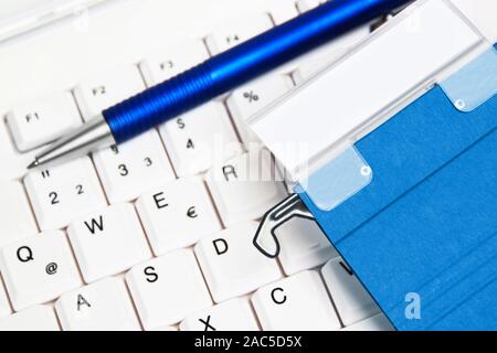 File folder with pen on keyboard Stock Photo