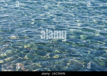 lava pebbles of the stomboli volcano under clear water texture, aeolian islands, italy Stock Photo