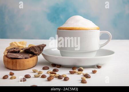 Coffee latte or cappuccino in a cup. Cafe and bar, barista art concept. Stock Photo