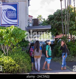 Local teenagers hang out near the Pacific Tsunami Museum in downtown Hilo, Big Island of Hawai'i. Stock Photo