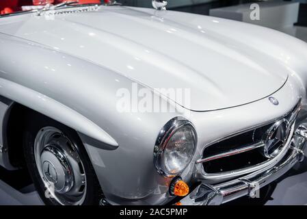 STUTTGART, GERMANY - OCTOBER 16, 2018: Mercedes Museum. Cropped photo. Red vintage automobile on a car show. Close up view on headlights Stock Photo