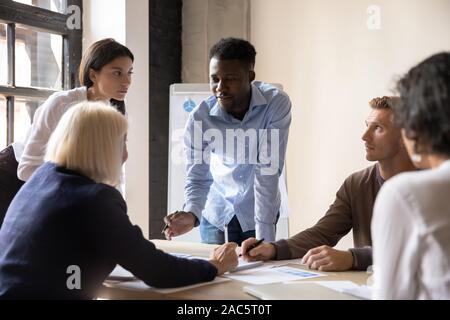 Focused diverse coworkers developing marketing strategy at office. Stock Photo