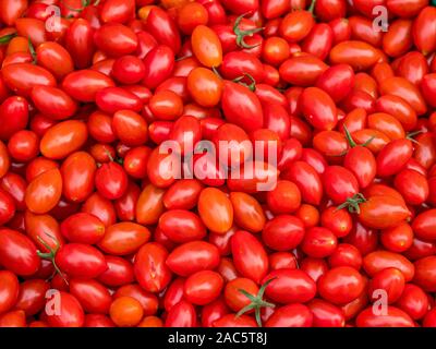 Full Frame Background of Fresh Ripe Red Cherry Tomatoes at a Local Marke Stock Photo
