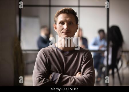 Head shot close up portrait of motivated young male employee. Stock Photo