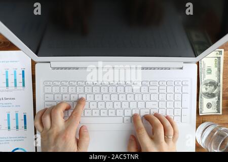 Male hands typing remote text on laptop keyboard Stock Photo