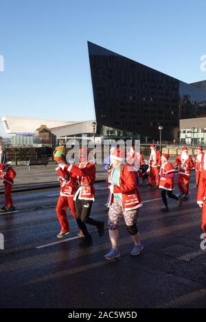 Liverpool, UK. 1st December 2019. Thousands of runners in red and blue Santa Suits take part in the annual 5km Santa Dash. Credit: Ken Biggs/Alamy Live News. Stock Photo