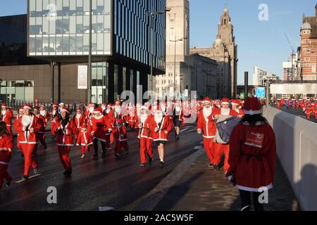 Liverpool, UK. 1st December 2019. Thousands of runners in red and blue Santa Suits take part in the annual 5km Santa Dash. Credit: Ken Biggs/Alamy Live News. Stock Photo