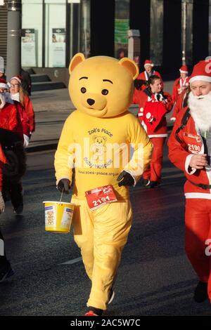 Liverpool, UK. 1st December 2019. Thousands of runners in red and blue Santa Suits take part in the annual 5km Santa Dash. Credit: Ken Biggs/Alamy Live News. Stock Photo