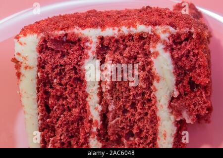 Red velvet cake, classic three layered cake from red butter sponge cakes with cream cheese frosting, American cuisine Stock Photo