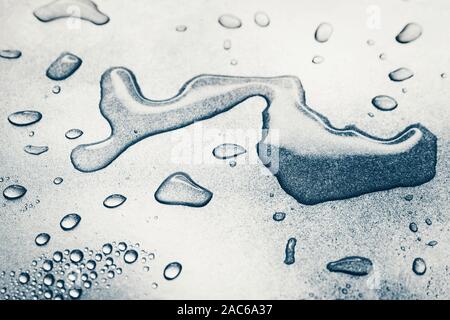Water drops on rough silvery background, close-up Stock Photo