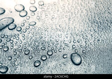 Water drops on rough silvery background, close-up Stock Photo