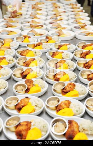 Many plates of airline food prepared in large-scale professional kitchen, toned image Stock Photo