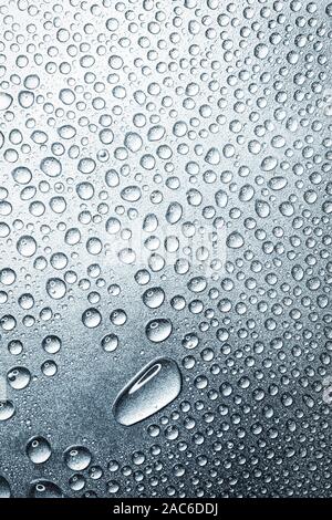 Water drops on rough silvery background, close-up Stock Photo