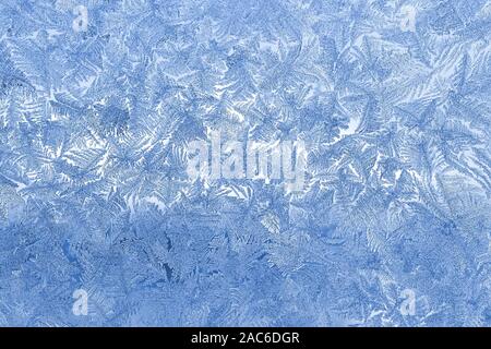 Blue frost on the glass. Abstract patterns. Macro. Stock Photo
