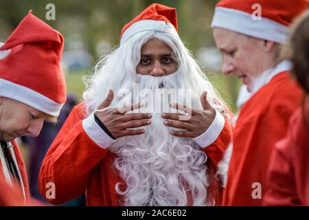 London, UK. 1st Dec 2019. Around two hundred runners join the annual 5k Santa Dash in Bexleyheath’s Danson Park for charitable causes. Credit: Guy Corbishley/Alamy Live News