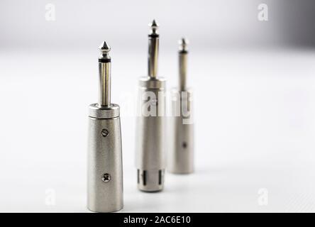 jack type metal audio connectors with balanced male and female canon inputs on white background Stock Photo