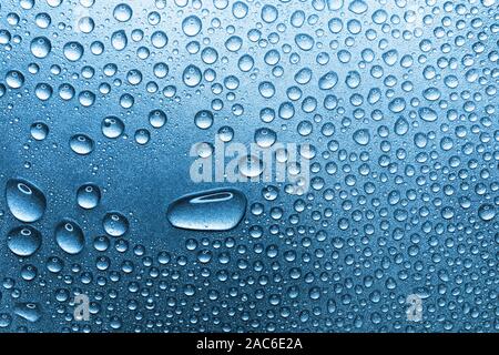 Water drops on rough silvery background, close-up Stock Photo