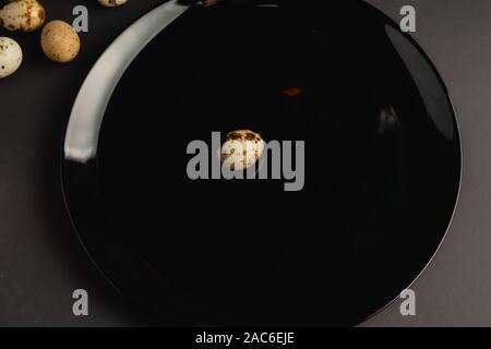 Quail eggs on a black background. Stock photo. Stock Photo