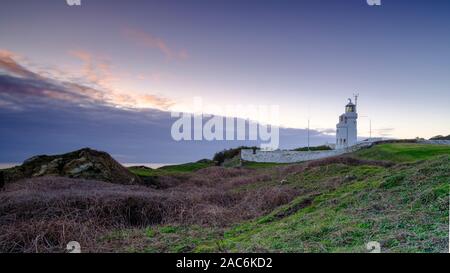 Niton, UK - November 29, 2019:  Sunset over St Catherine's Point Light House from near Reeth Bay on the Isle of Wight, UK Stock Photo