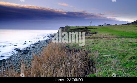 Niton, UK - November 29, 2019:  Sunset over St Catherine's Point Light House from near Reeth Bay on the Isle of Wight, UK Stock Photo