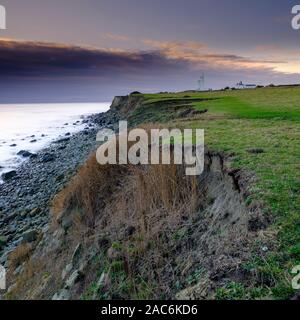 Niton, UK - November 29, 2019:  Sunset over St Catherine's Point Light House from near Reeth Bay on the Isle of Wight, UK Stock Photo