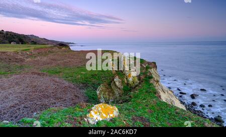 Niton, UK - November 29, 2019:  Sunset over St Catherine's Point Light House from near Reeth Bay on the Isle of Wight, UK Stock Photo