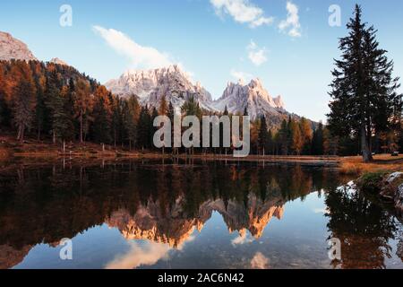 Deep autumn. Gorgeous mountains in clouds. Great landscape. Woods near the lake Stock Photo