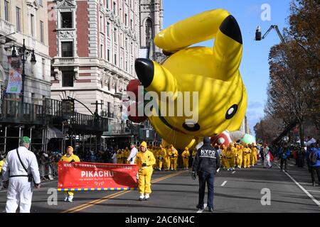 Pikachu by Pokemon giant balloon flown low because of high wind during the 93rd Annual Macy's Thanksgiving Day Parade in New York City. Stock Photo