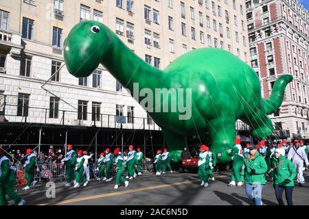 Sinclair's Dino giant balloon flown low because of high wind during the 93rd Annual Macy's Thanksgiving Day Parade in New York City. Stock Photo