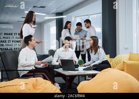 Group of young freelancers in the office have conversation and smiling Stock Photo