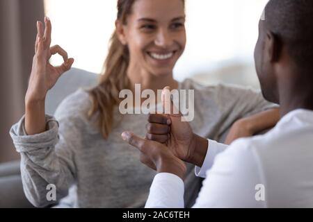 Hearing impaired disabled happy family couple showing gestures. Stock Photo