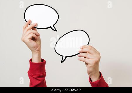 Hand holding two blank speech bubble sign ready for message Stock Photo
