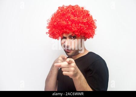 Hey you, beauty! Portrait of funny positive man with bristle and red wig pointing to camera and winking playfully, flirting and getting acquaintance, Stock Photo