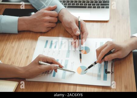 business people discussing on performance revenue in meeting. businessman working with co-worker team. financial adviser analyzing data with investor. Stock Photo