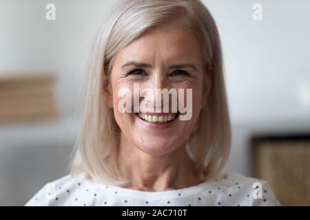Close up portrait beautiful cheery older woman Stock Photo