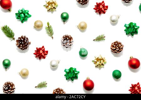 Christmas pattern with red, green and golden  balls, bows, fir branches and pine cones isolated on white Stock Photo