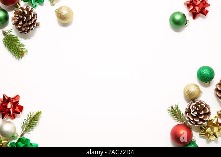 Christmas frame with red, green and golden  balls, bows, fir branches and pine cones isolated on white Stock Photo