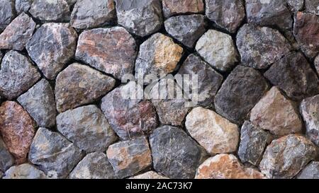 pattern gray color of rustic country style design decorative dreal stone wall surface with cement. Background of ancient stone wall. Texture of old . Stock Photo