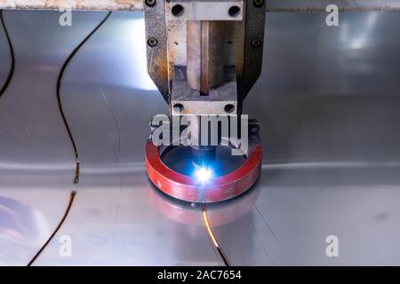 Close-up of metal processing machine. Plasma metal cutting. Production of metal pipes. Stock Photo