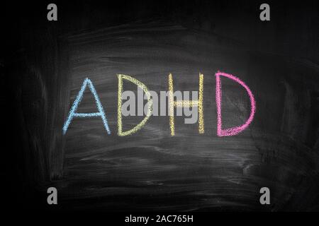 ADHD. Abbreviation ADHD on a blackboard. ADHD is Attention deficit hyperactivity disorder. Stock Photo