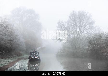 Narrowboat moored on canal in Winter frost Stock Photo