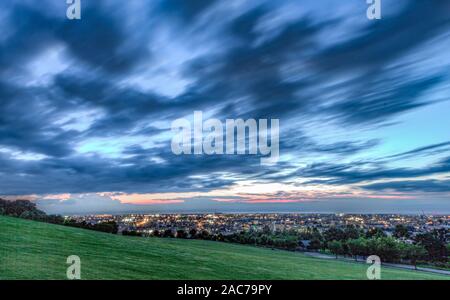 Long-exposure  summer evening view with blurred cloudscape of Kanazawa city from Daijouji Hill Park, looking West towards the Japan Sea. Stock Photo