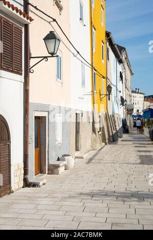 Colorful facades in the harbor of the old town of Cres glow in the morning sun, Kvarner Bay, Croatia Stock Photo