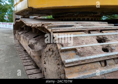 Metal track drive of a large excavator, visible up close. Stock Photo