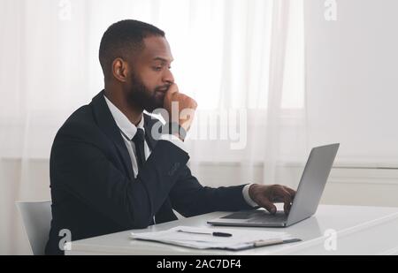 Young african american businessman studying market online Stock Photo