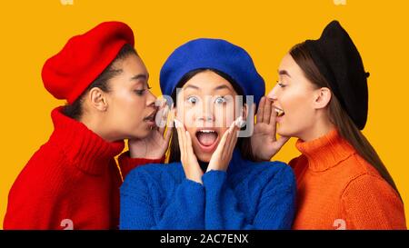 Diverse Young Women Sharing Gossips Standing On Yellow Background, Panorama Stock Photo
