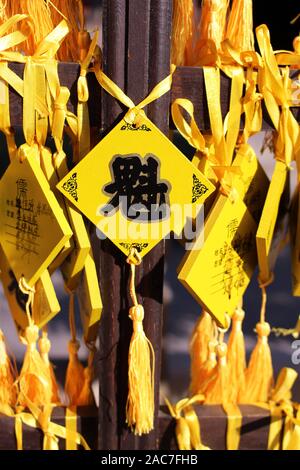 Chinese yellow lucky prayer charms at the Sacred Confucius Temple in Beijing, China, 2019. Stock Photo