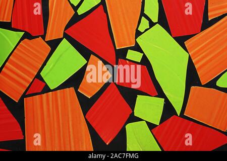 Colourful mosaic of green red and orange tiles with black outlines