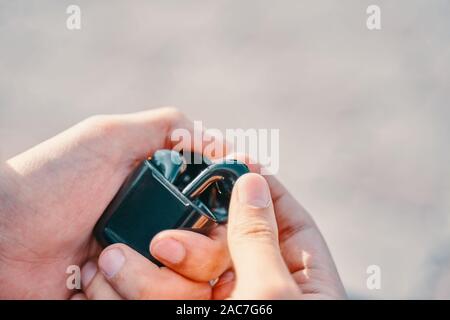 Bishkek, Kyrgyzstan - October 10, 2019: Man holding a custom black airpods from apple and pulls one earpiece out of the case Stock Photo