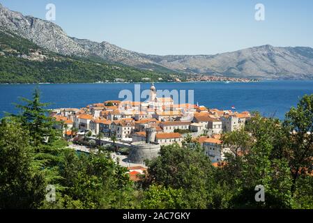 The medieval old town of Korčula in front of the mountainous Pelješac peninsula in sunshine, South Dalmatia, Croatia Stock Photo